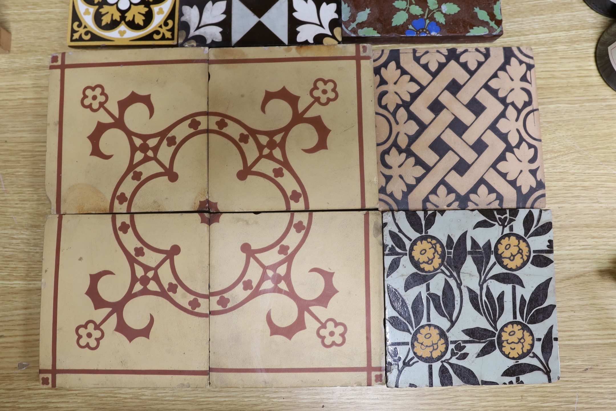 A selection of 19th and 20th century tiles, including Minton encaustic and W. Godwin tiles